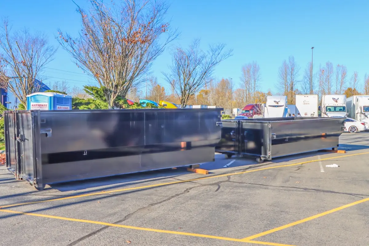 Professional dumpster rental service with roll-off container on residential driveway in South Beloit